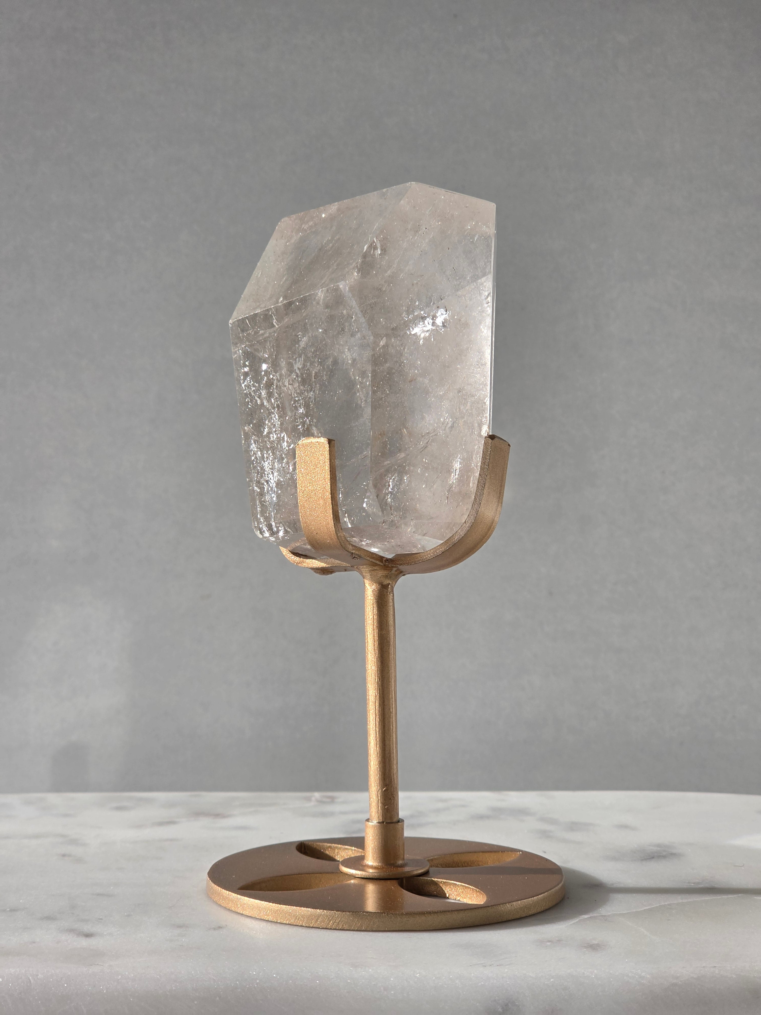 Clear Quartz freeform crystal with subtle smoky-grey translucence, natural internal inclusions and luminous clarity, displayed on an elegant gold-finished stand.