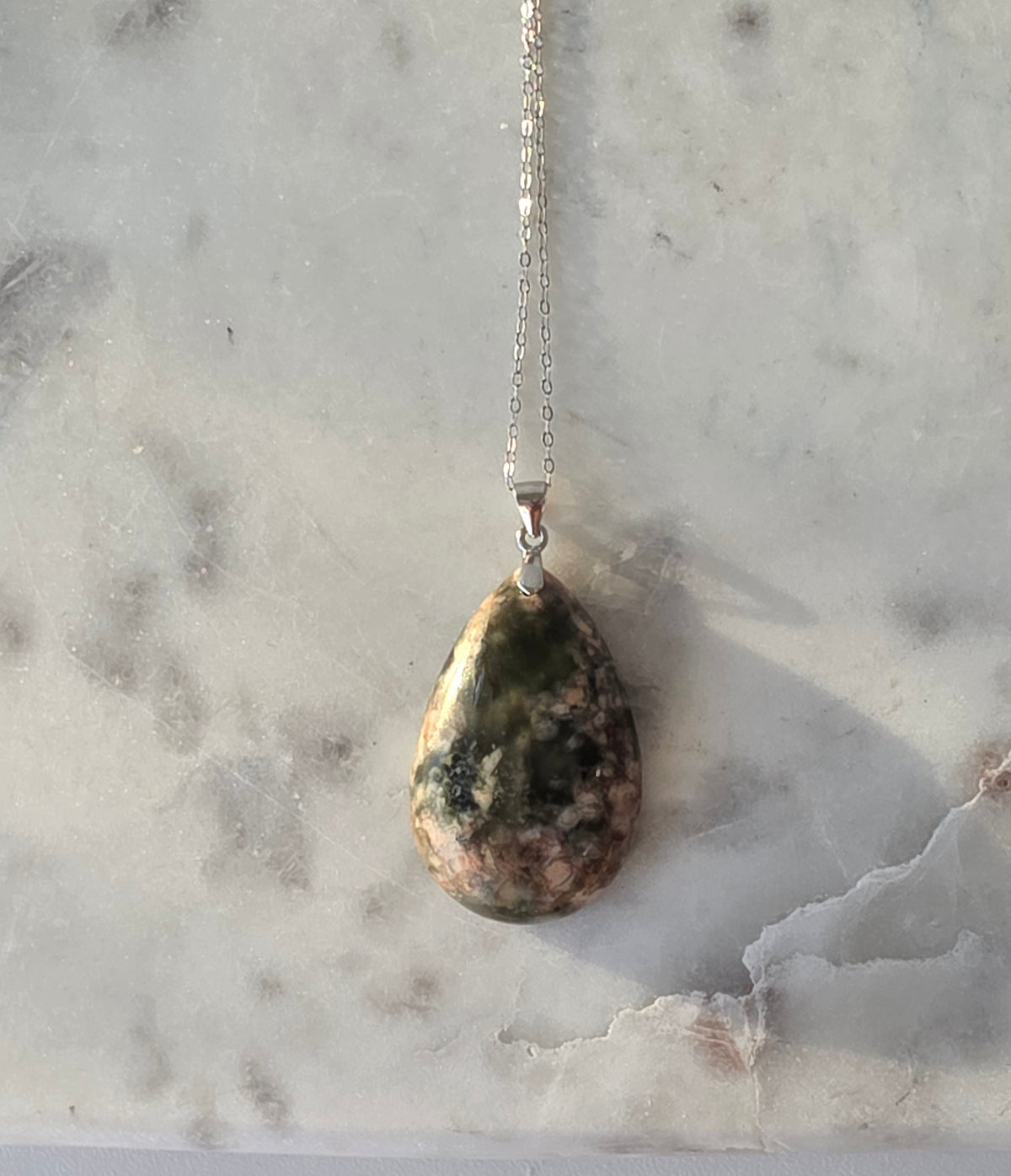 Natural Flower Agate teardrop pendant in 925 sterling silver with matching silver chain, featuring soft pink and white floral patterns