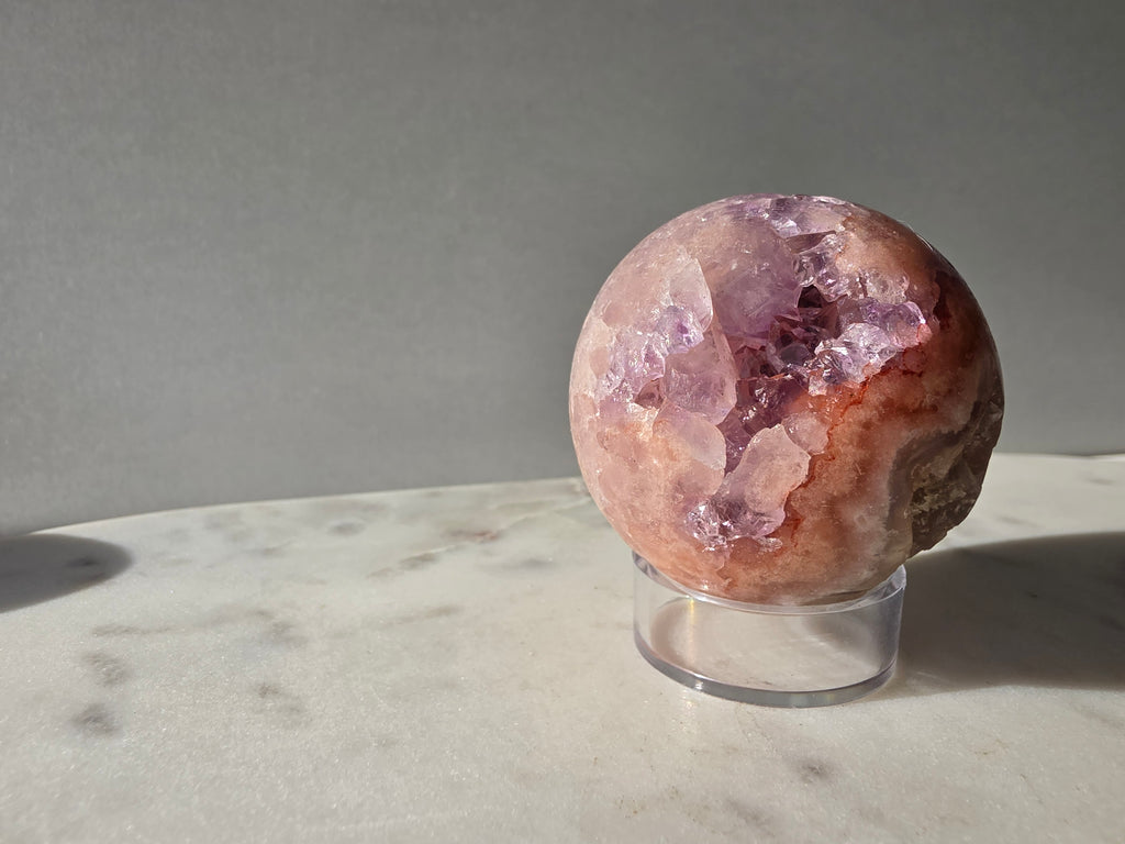 Luxury Pink Amethyst crystal sphere from Brazil with soft blush and lilac tones and a dramatic sparkling crystalline interior