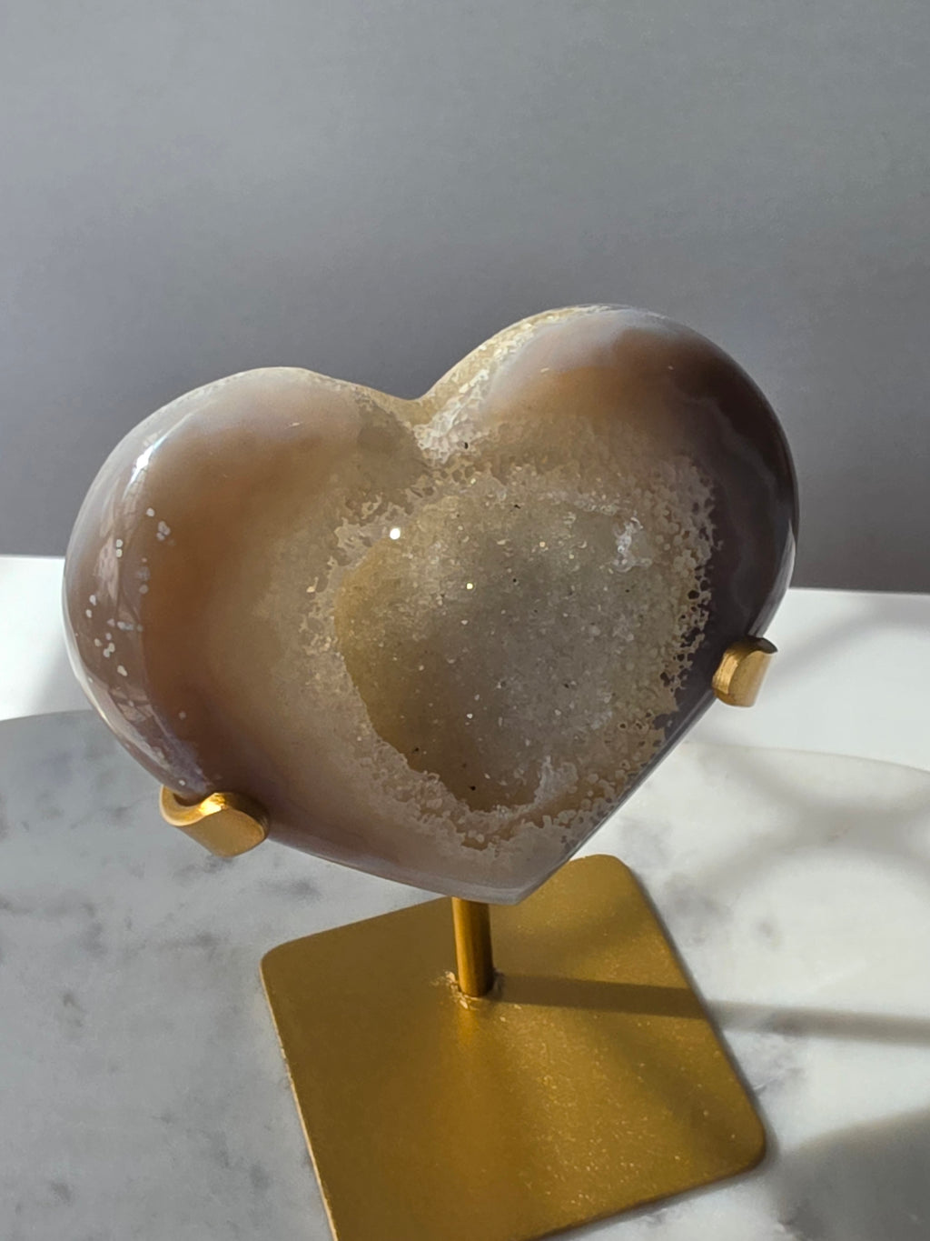 High clarity Druzy Agate Geode Heart on gold stand featuring sparkling druzy crystals, natural agate banding and champagne, taupe and smoky grey tones