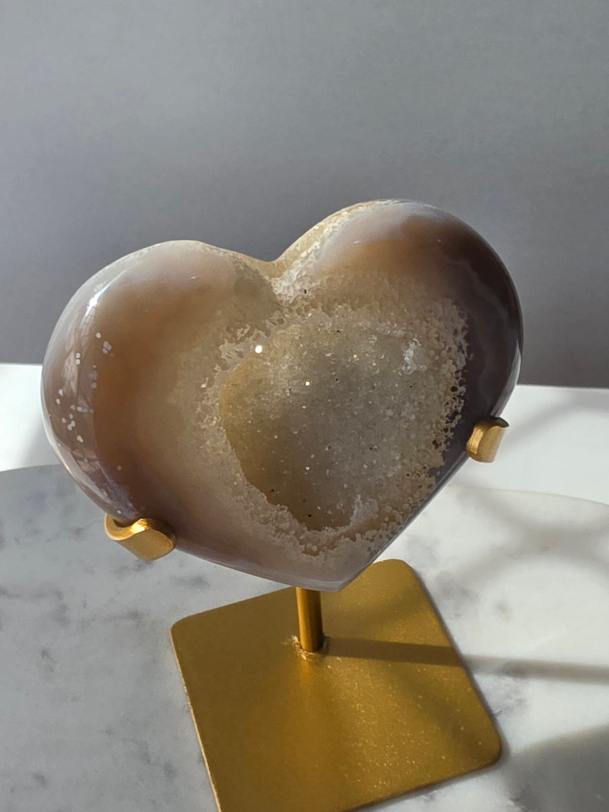 High clarity Druzy Agate Geode Heart on gold stand featuring sparkling druzy crystals, natural agate banding and champagne, taupe and smoky grey tones