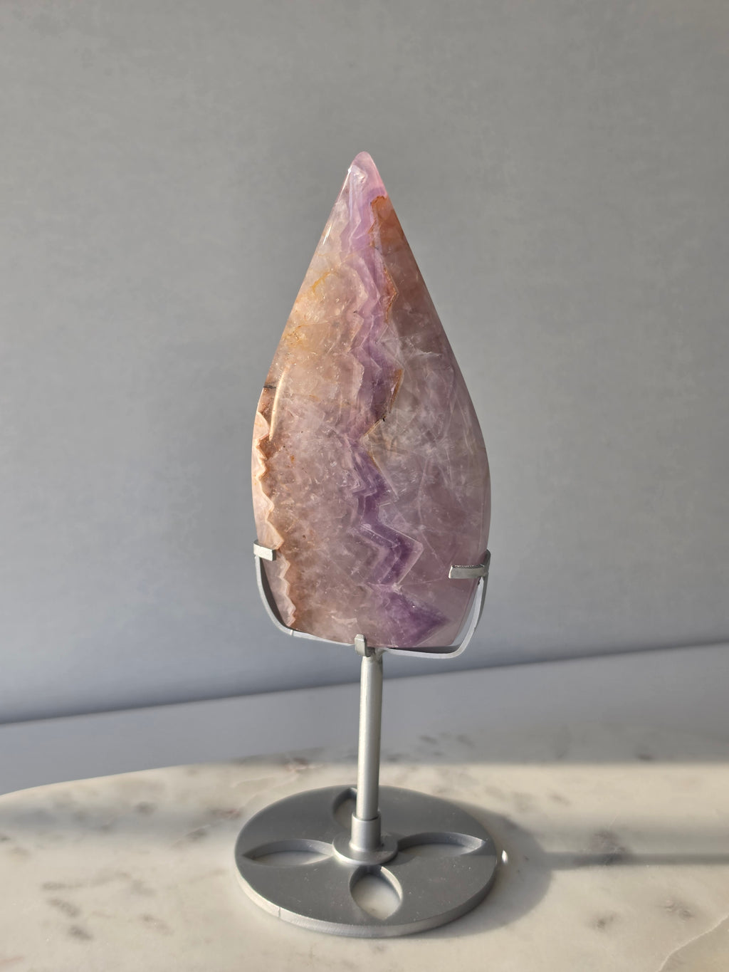 Amethyst Lace Agate flame on a silver stand featuring soft lavender, lilac and creamy white natural banding and intricate lace-like patterns, luxury crystal décor.