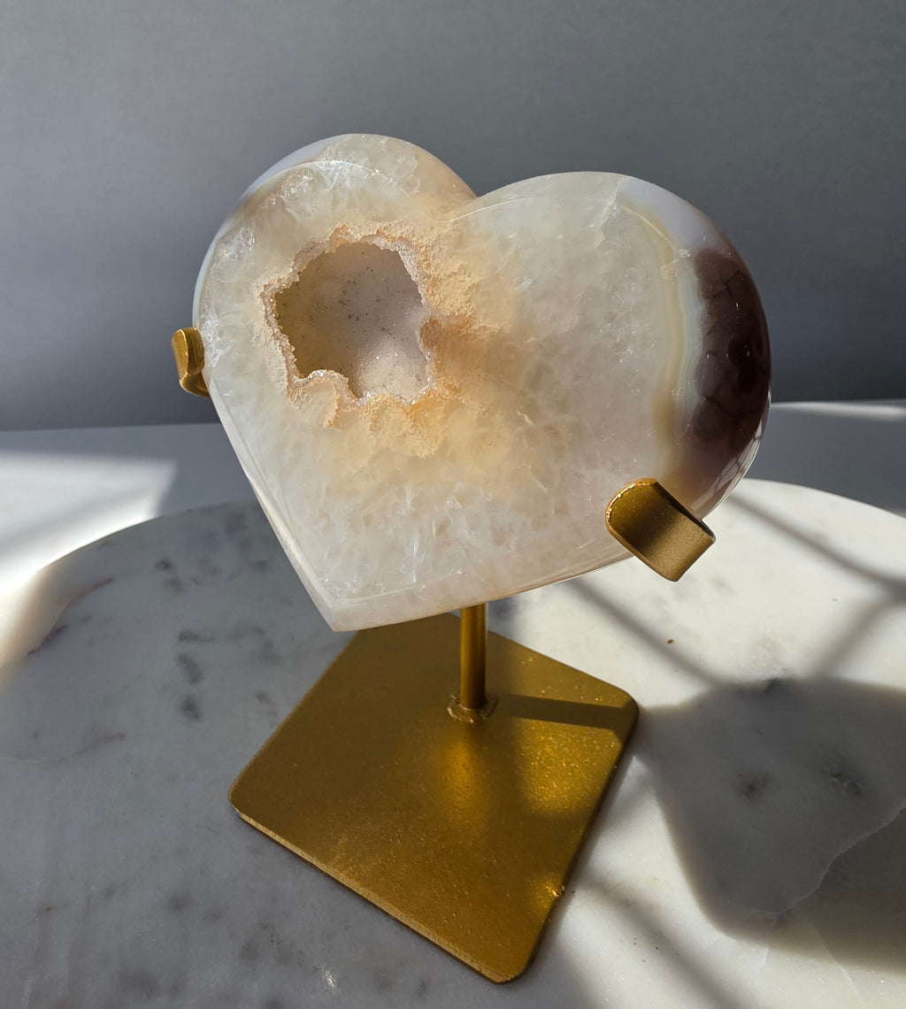 High Clarity Druzy Agate Geode Heart on a gold stand featuring sparkling druzy quartz crystals and natural champagne, caramel, ivory, taupe and smoky-grey agate banding.