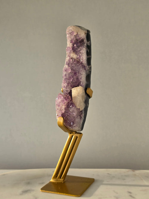 Brazilian Purple Amethyst Freeform with natural golden Calcite on gold stand, featuring sparkling druzy crystal points and polished finish – luxury crystal home décor by Stone & Bloom.