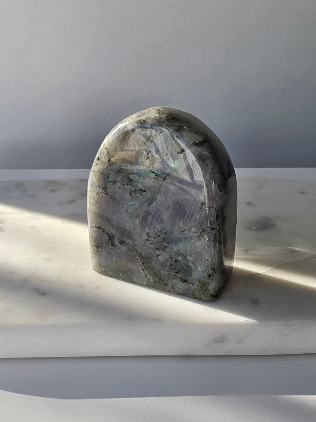 353g polished Labradorite cut base featuring vivid blue, turquoise and golden-green iridescent flashes across a smoky grey and charcoal natural stone.