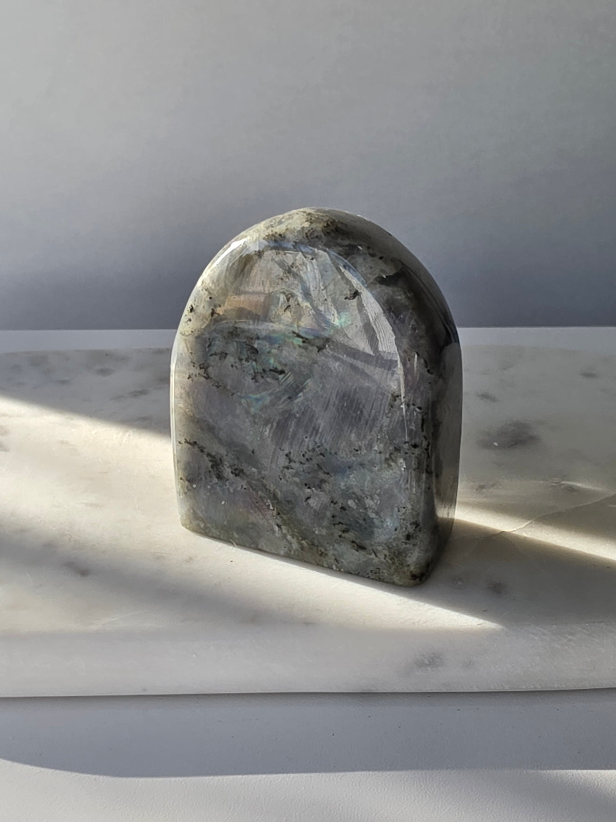 353g polished Labradorite cut base featuring vivid blue, turquoise and golden-green iridescent flashes across a smoky grey and charcoal natural stone.