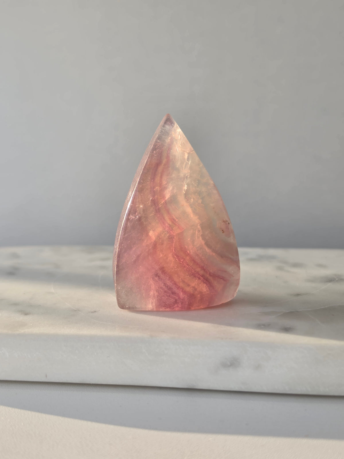 Natural Candy Fluorite crystal flame with pastel purple, blue and green tones, translucent colour zoning and polished finish