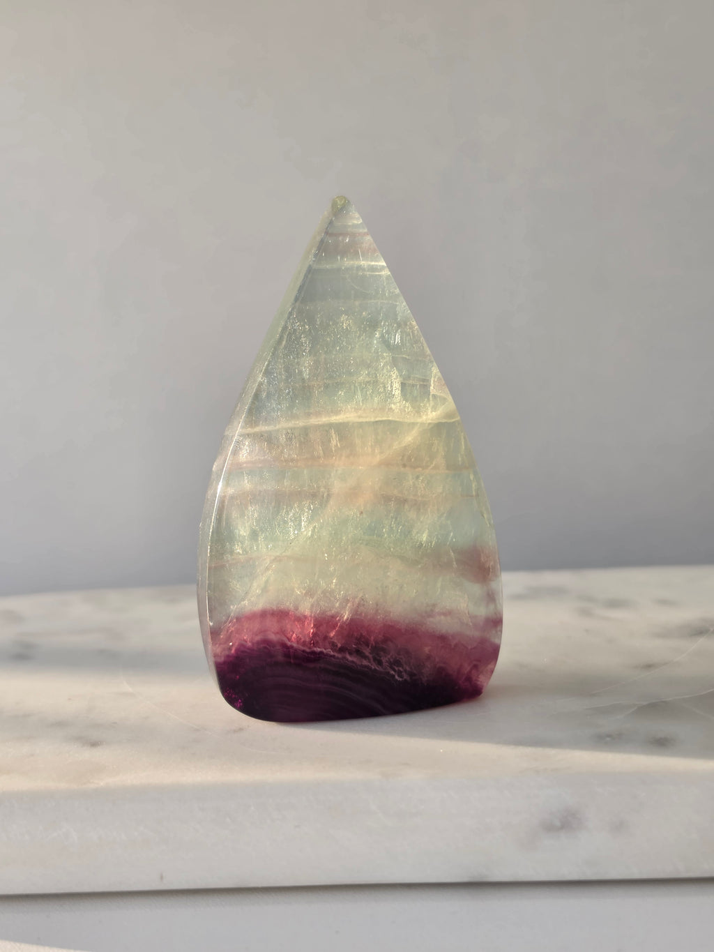 Shop Candy Fluorite Flames featuring dreamy pastel purple, blue and green tones, beautiful natural colour zoning and a polished sculptural finish.