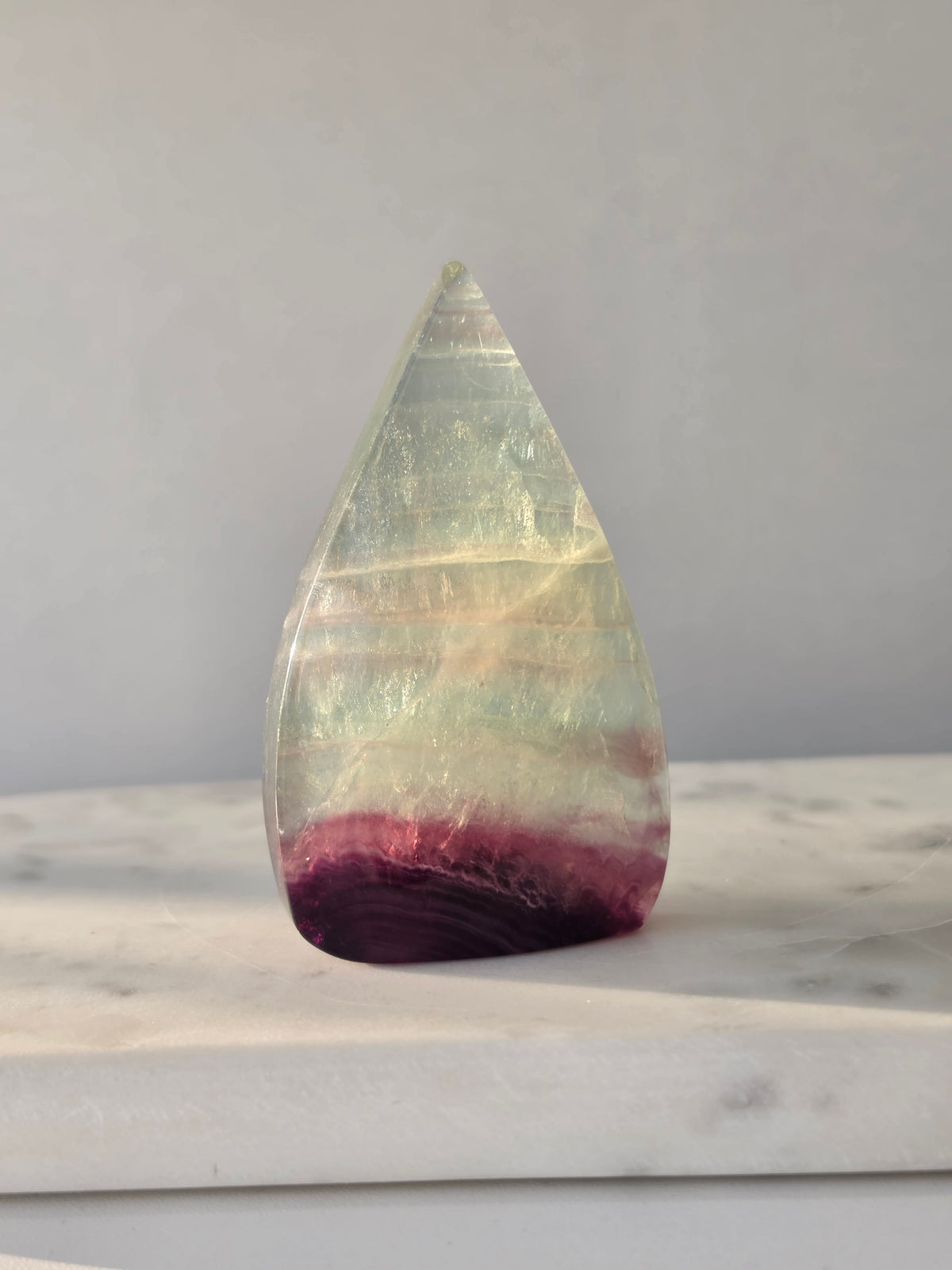 Shop Candy Fluorite Flames featuring dreamy pastel purple, blue and green tones, beautiful natural colour zoning and a polished sculptural finish.