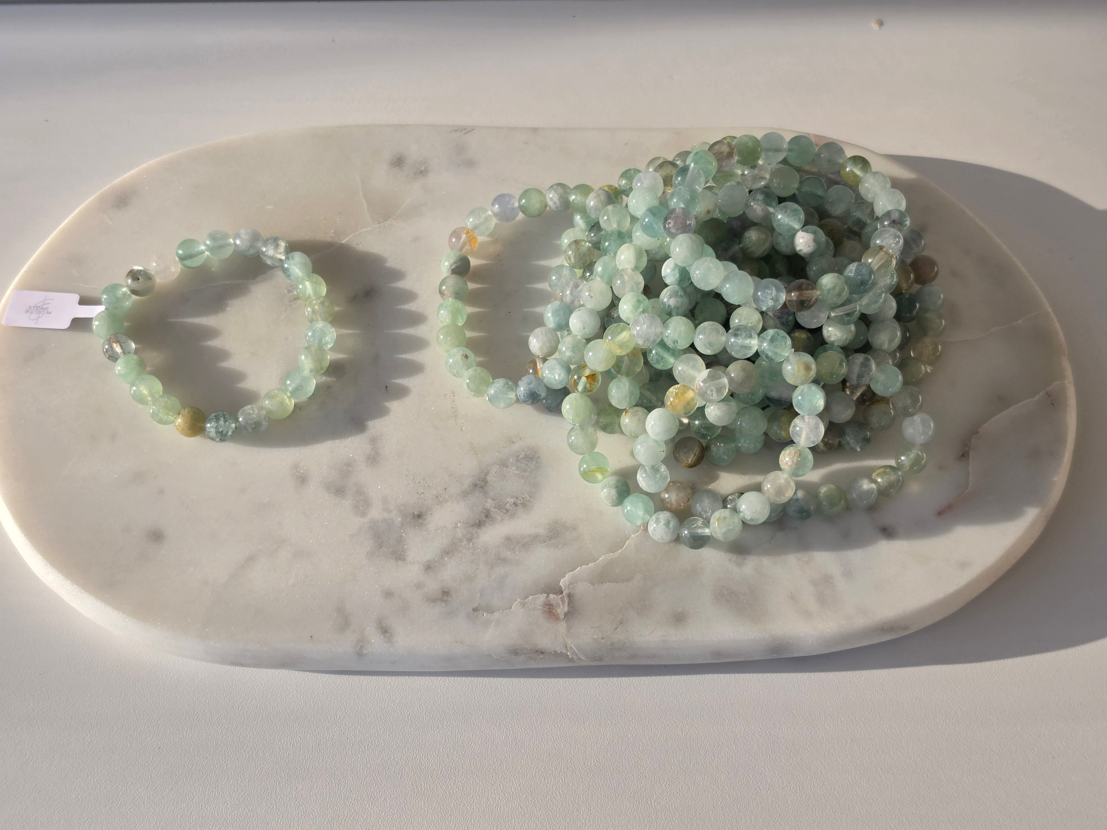 Natural Green Fluorite bracelet with polished translucent mint-green gemstone beads, luxury crystal jewellery by Stone & Bloom.
