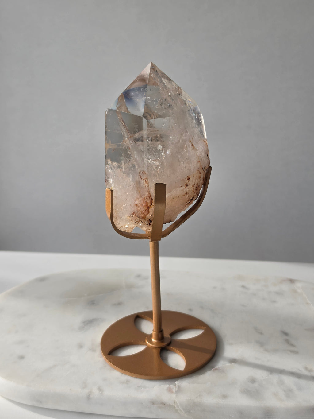 High-grade Nepalese Pink Himalayan Quartz statement piece, 606g and 19cm tall, featuring delicate pink tones, translucent crystal formations and natural inclusions, displayed on a gold stand.