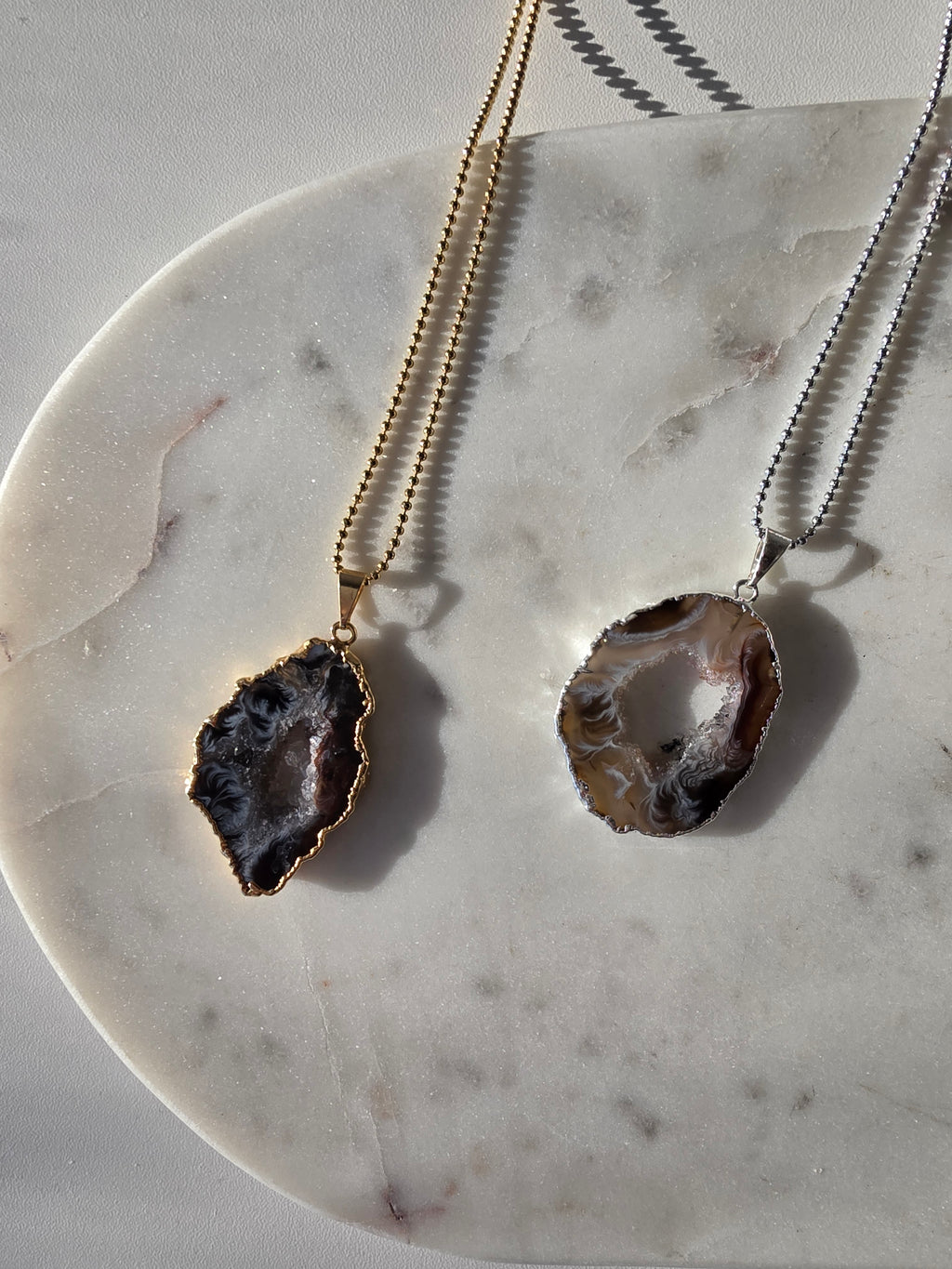 "Brazilian Agate Geode Slice Pendant in natural [brown/black/grey] tones on a silver plated chain with sparkling druzy crystal formations"