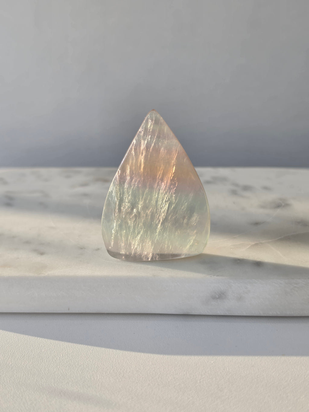 Natural Candy Fluorite crystal flame with pastel purple, blue and green tones, translucent colour zoning and polished finish