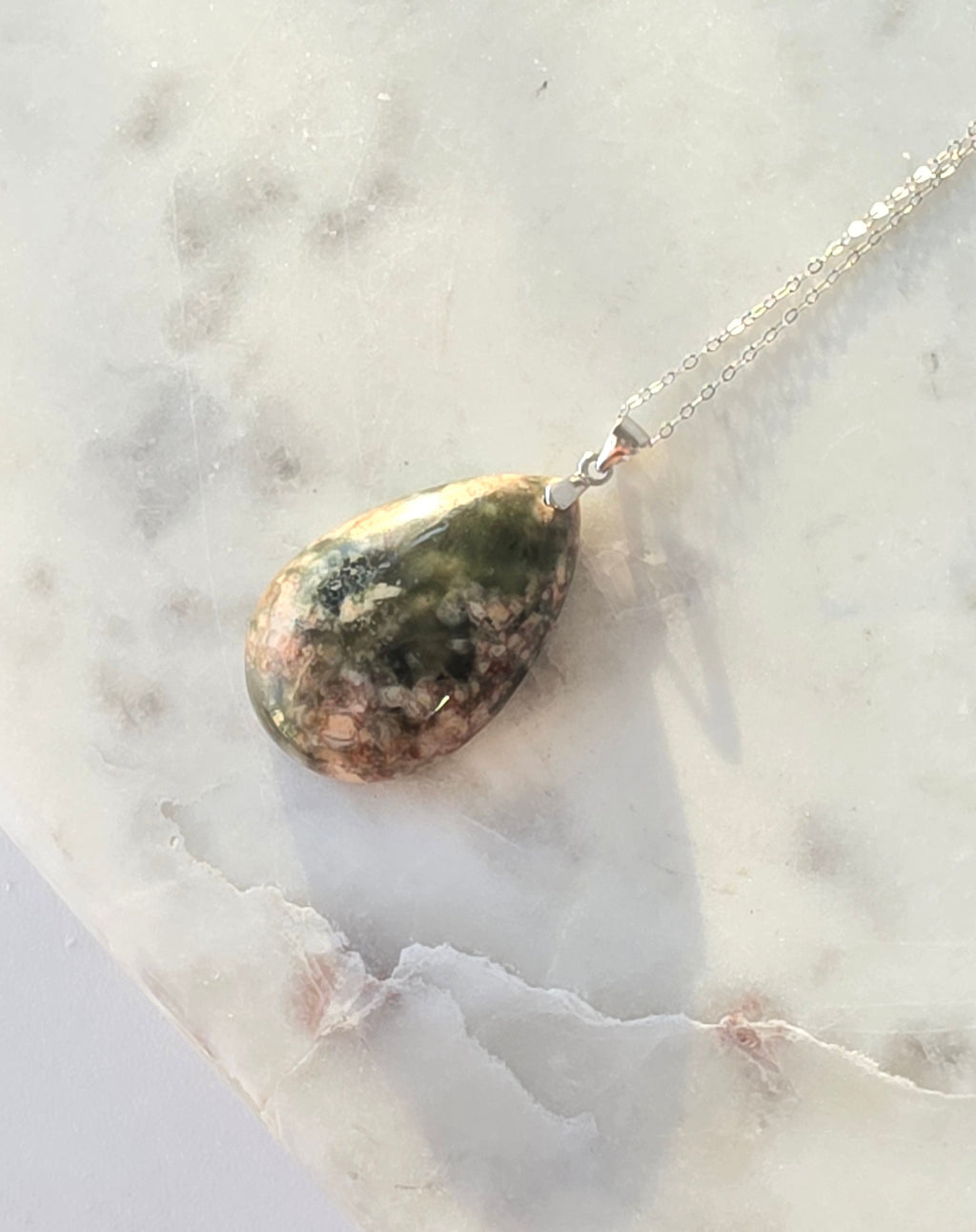 Natural Flower Agate teardrop pendant in 925 sterling silver with matching silver chain, featuring soft pink and white floral patterns