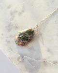 Natural Flower Agate teardrop pendant in 925 sterling silver with matching silver chain, featuring soft pink and white floral patterns