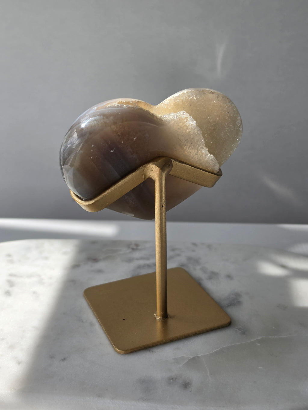 High clarity Druzy Agate Geode Heart on gold stand featuring sparkling druzy crystals, natural agate banding and champagne, taupe and smoky grey tones