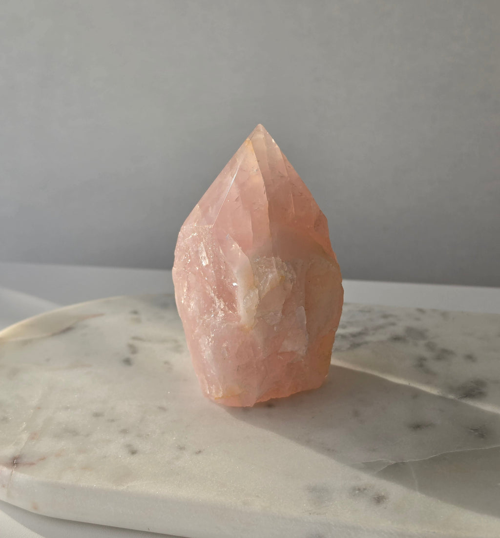 Natural Rose Quartz tower with soft blush-pink colouring and subtle warm golden healer inclusions, weighing 466g and measuring 10cm