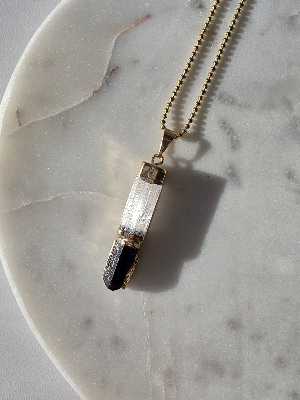 Natural Selenite and Black Tourmaline crystal pendant in a refined 24K Gold Plated setting, Stone & Bloom Raw Luxe Collection