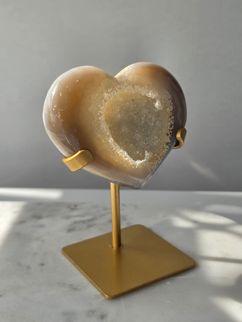 High clarity Druzy Agate Geode Heart on gold stand featuring sparkling druzy crystals, natural agate banding and champagne, taupe and smoky grey tones