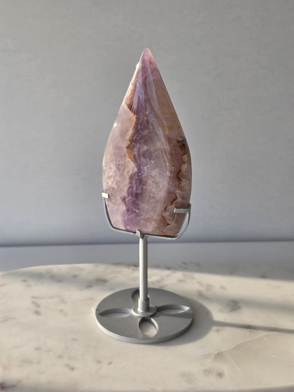 Amethyst Lace Agate flame on a silver stand featuring soft lavender, lilac and creamy white natural banding and intricate lace-like patterns, luxury crystal décor.