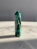 Polished green Malachite Point featuring deep emerald bands, concentric bubble-like formations with sparkles and intricate natural patterns.