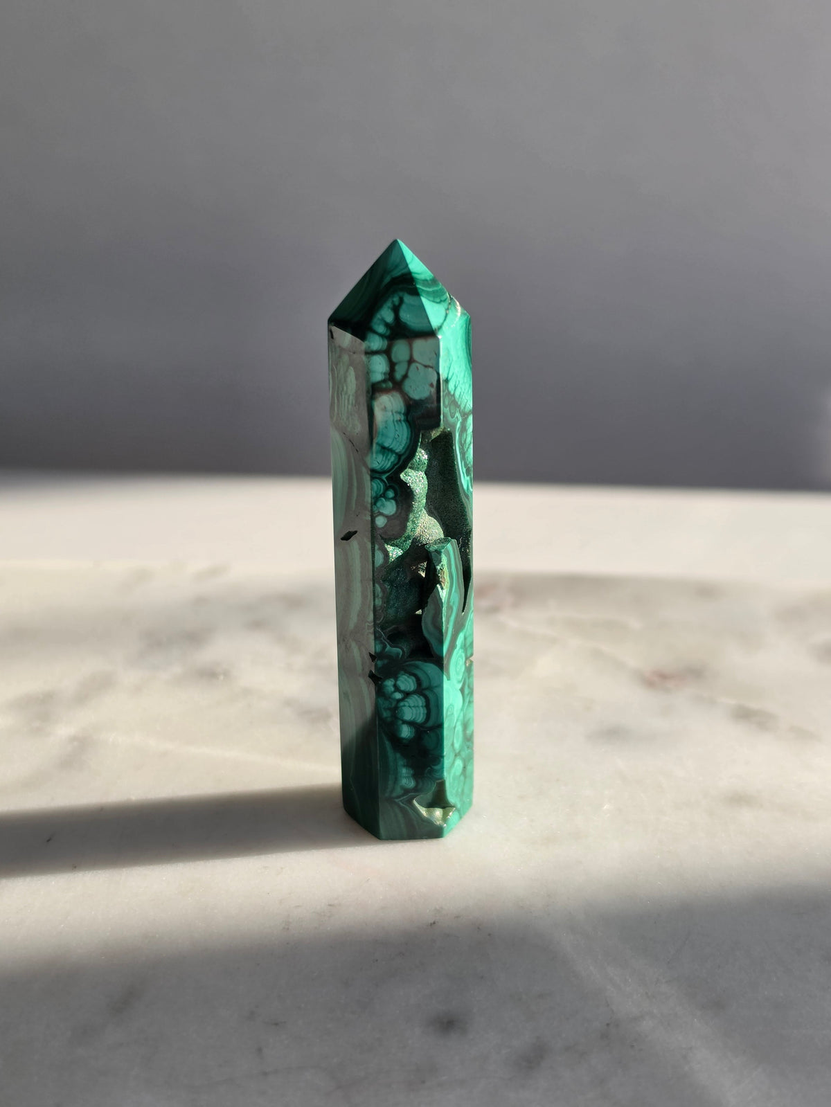Polished green Malachite Point featuring deep emerald bands, concentric bubble-like formations with sparkles and intricate natural patterns.