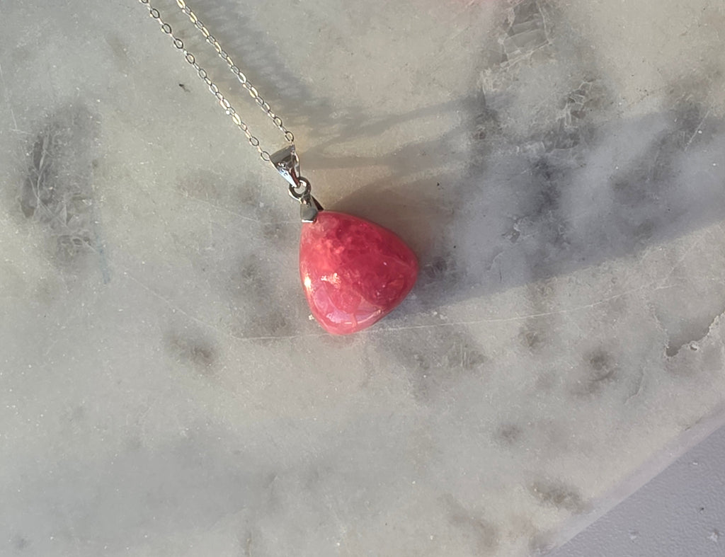 Natural Rhodochrosite teardrop pendant in 925 sterling silver with matching silver chain, featuring vibrant pink tones and unique natural patterns
