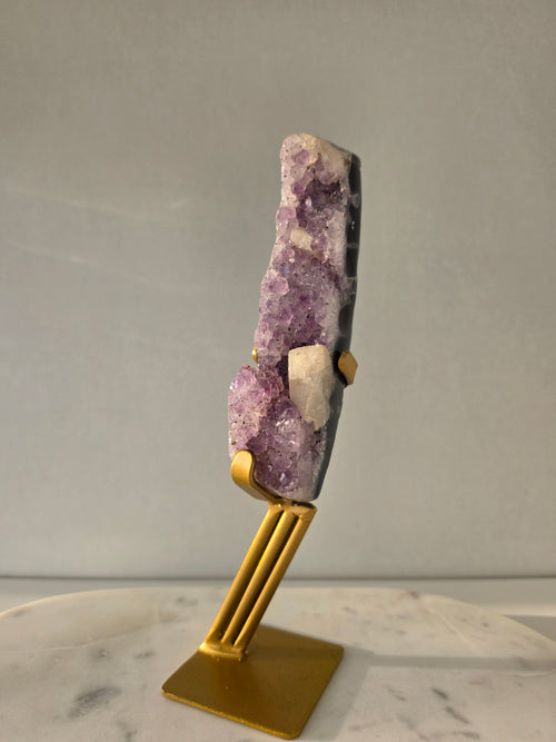 Brazilian Purple Amethyst Freeform with natural golden Calcite on gold stand, featuring sparkling druzy crystal points and polished finish – luxury crystal home décor by Stone & Bloom.