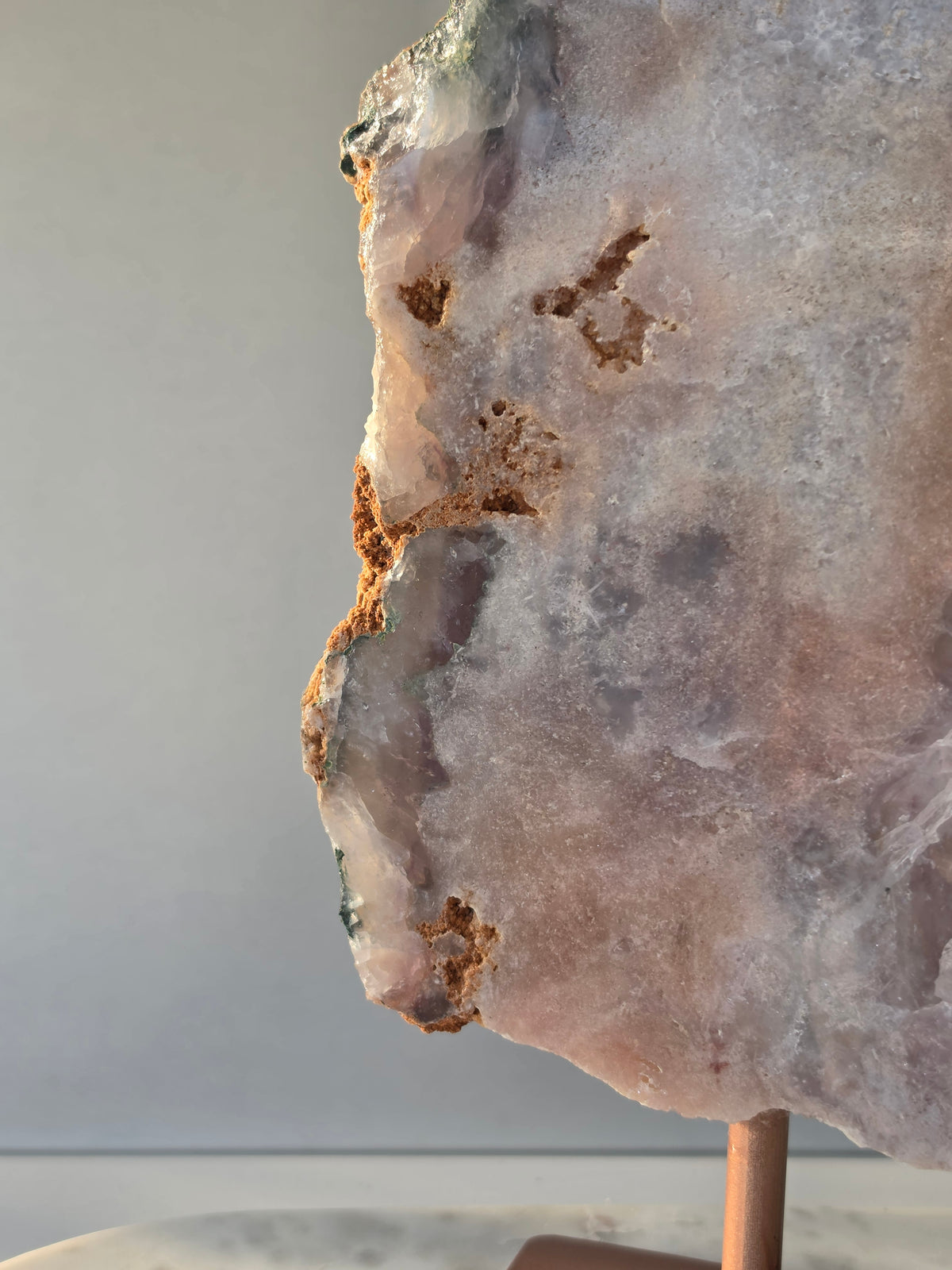 Large Brazilian Pink Amethyst slice on display stand with translucent Quartz, sparkling crystalline texture, earthy brown Jasper features and deep green natural matrix