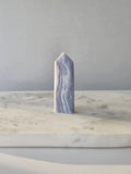 Natural Blue Lace Agate crystal point with soft blue and white banding, polished finish and unique natural formations