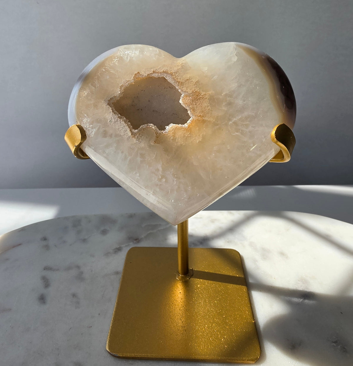 High Clarity Druzy Agate Geode Heart on a gold stand featuring sparkling druzy quartz crystals and natural champagne, caramel, ivory, taupe and smoky-grey agate banding.