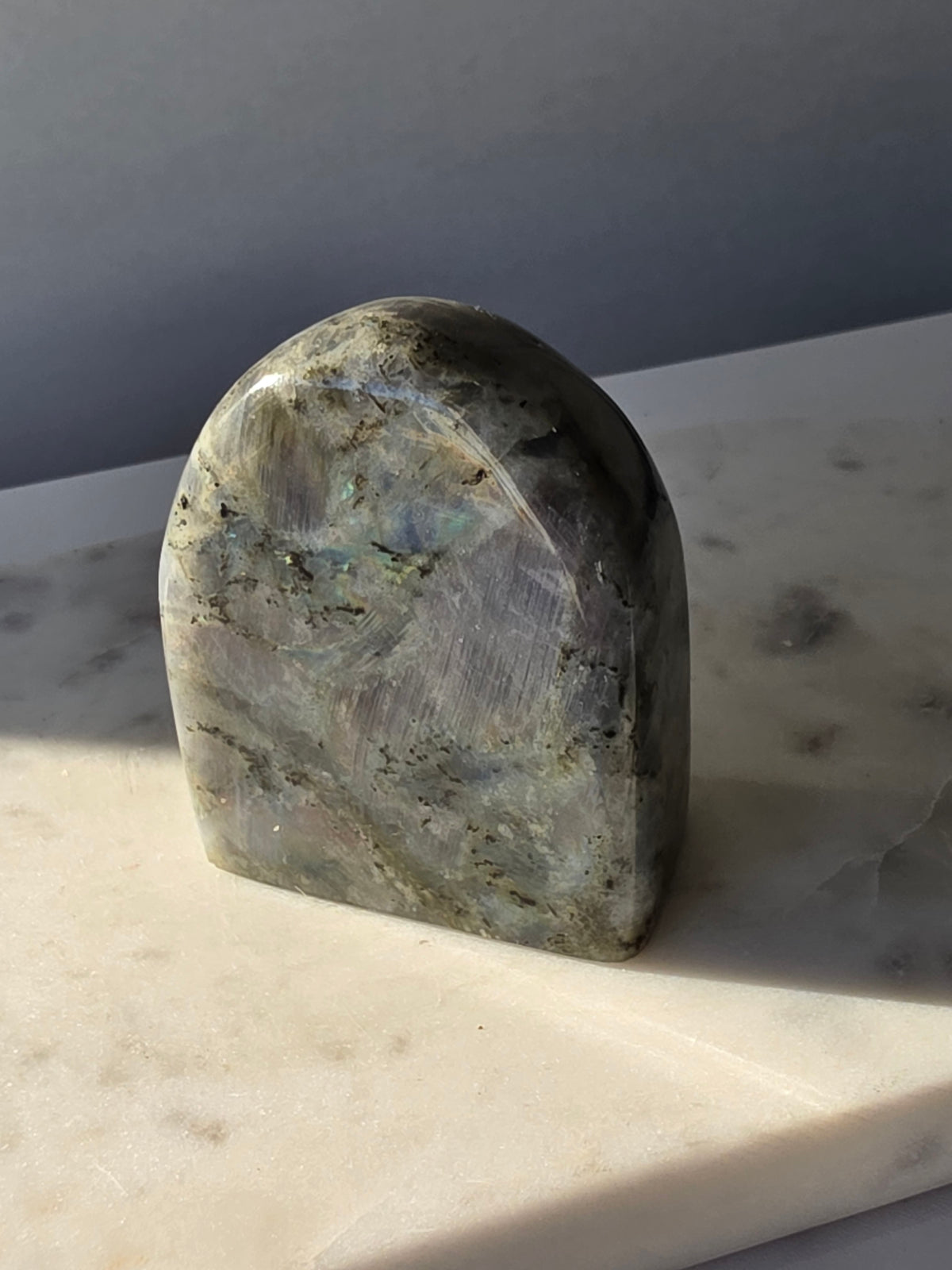 353g polished Labradorite cut base featuring vivid blue, turquoise and golden-green iridescent flashes across a smoky grey and charcoal natural stone.