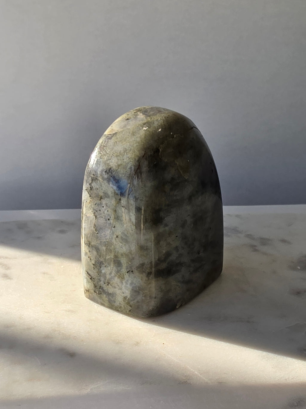 353g polished Labradorite cut base featuring vivid blue, turquoise and golden-green iridescent flashes across a smoky grey and charcoal natural stone.