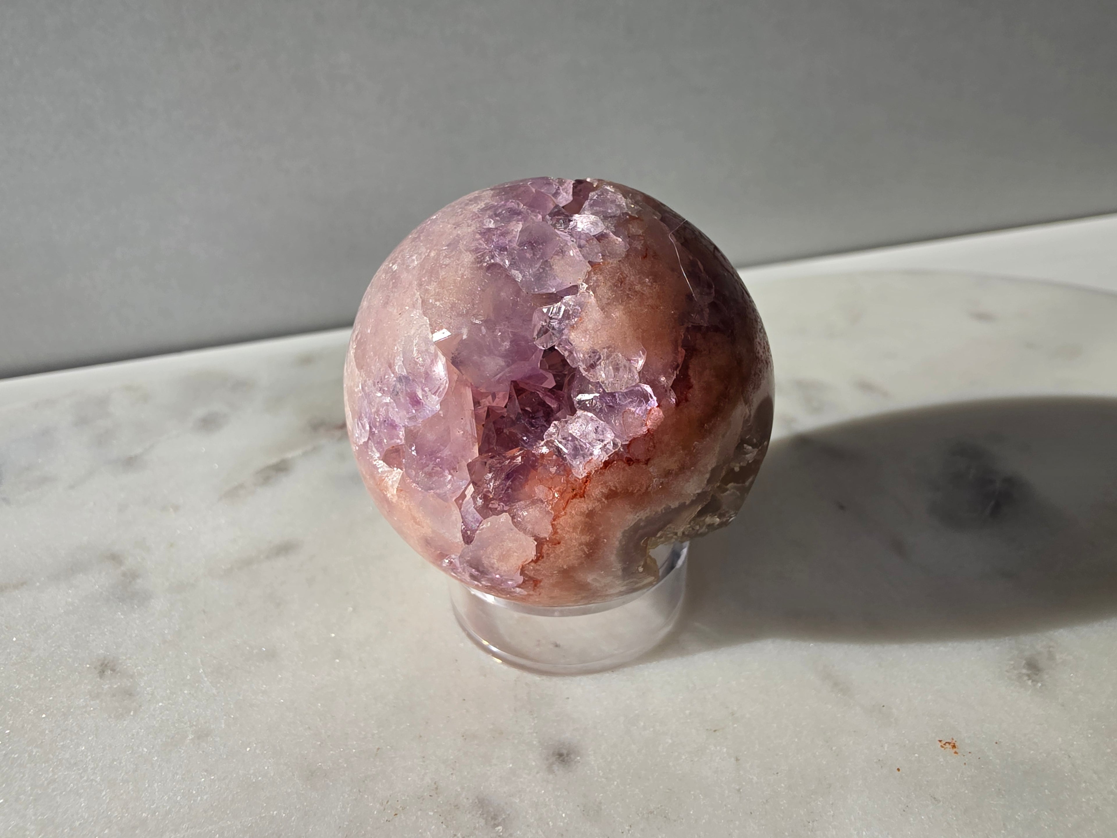 Luxury Pink Amethyst crystal sphere from Brazil with soft blush and lilac tones and a dramatic sparkling crystalline interior