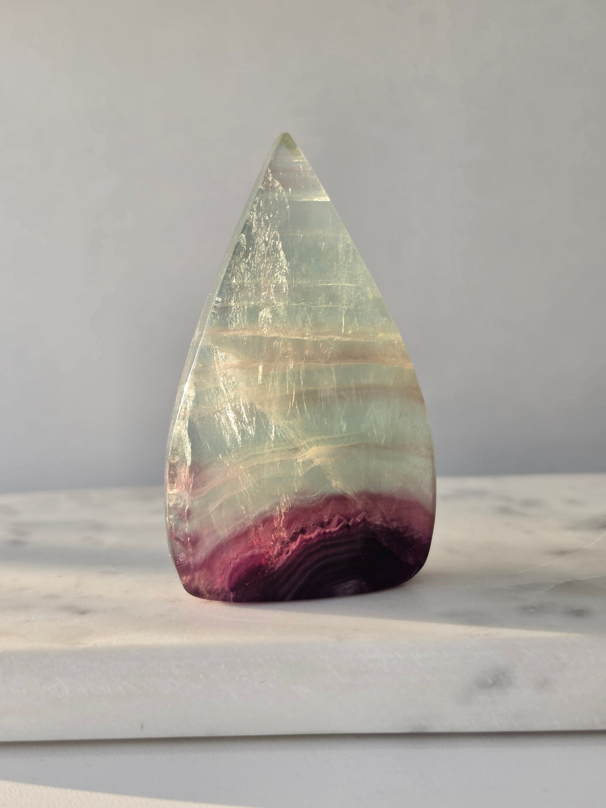 Shop Candy Fluorite Flames featuring dreamy pastel purple, blue and green tones, beautiful natural colour zoning and a polished sculptural finish.
